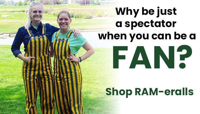 Two students wearing green and gold striped overalls.